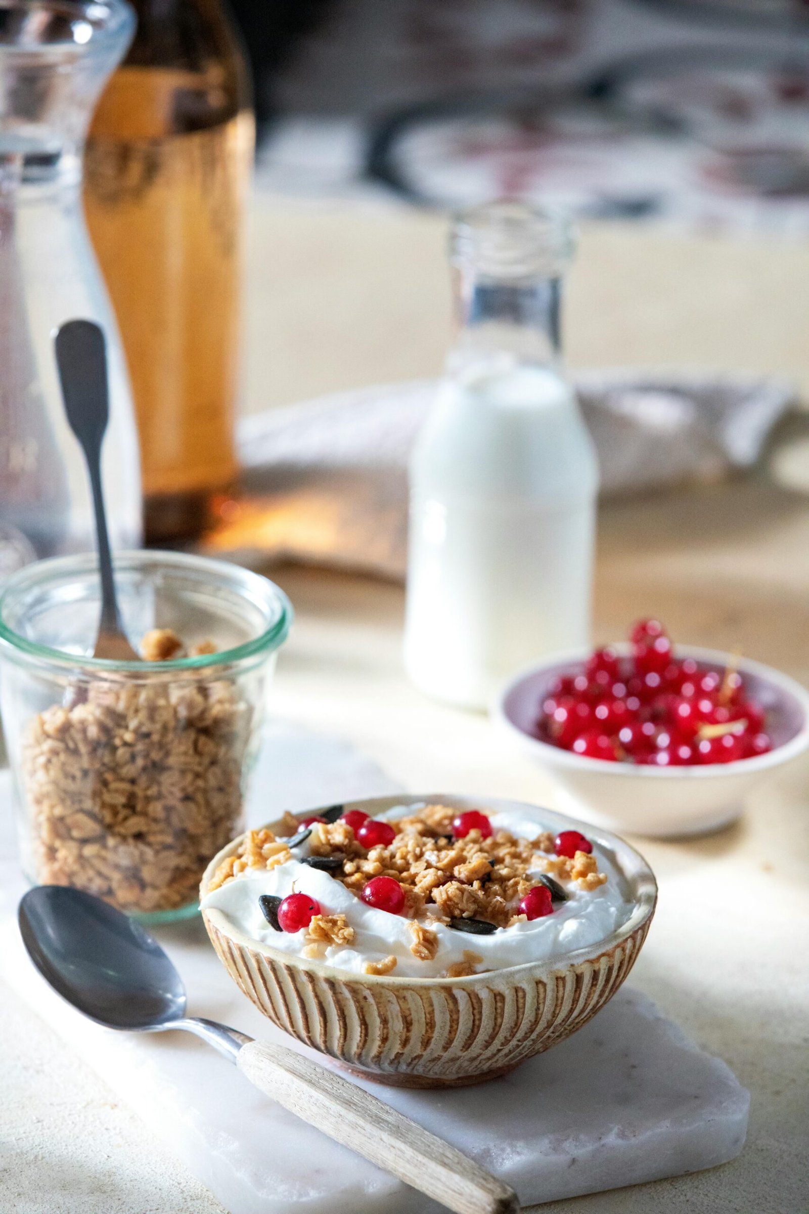 Delicious yogurt bowl topped with granola and red currants, perfect for a healthy breakfast.